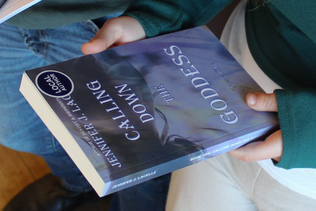 A upside-down photo of someone holding a book.