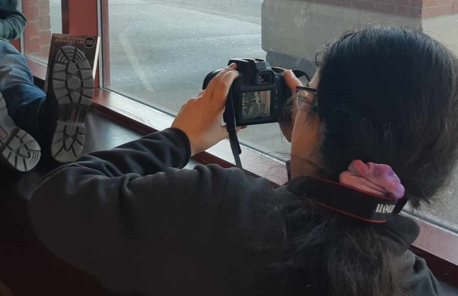 Magalie is taking a photo.