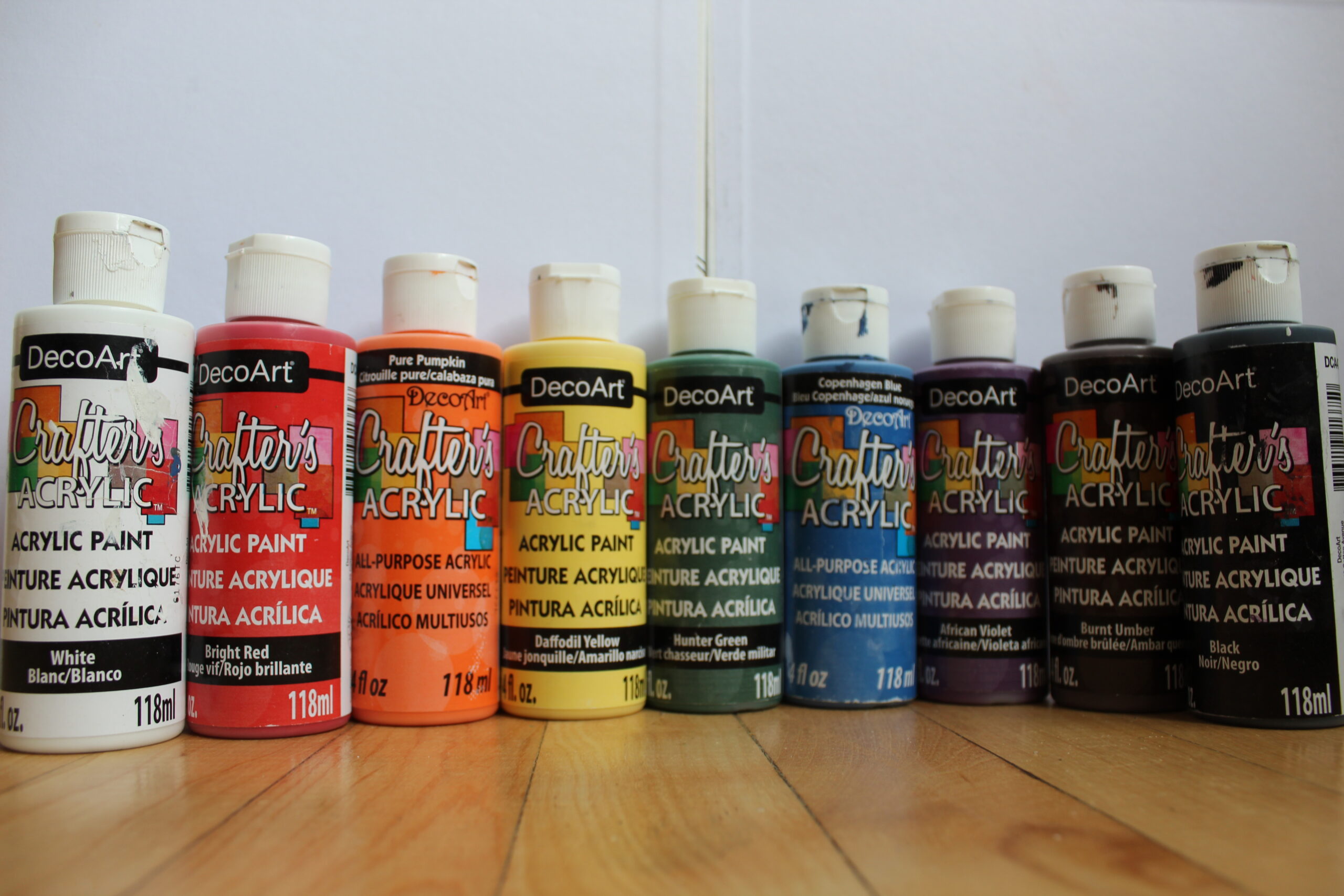 A curved row of paint bottles.