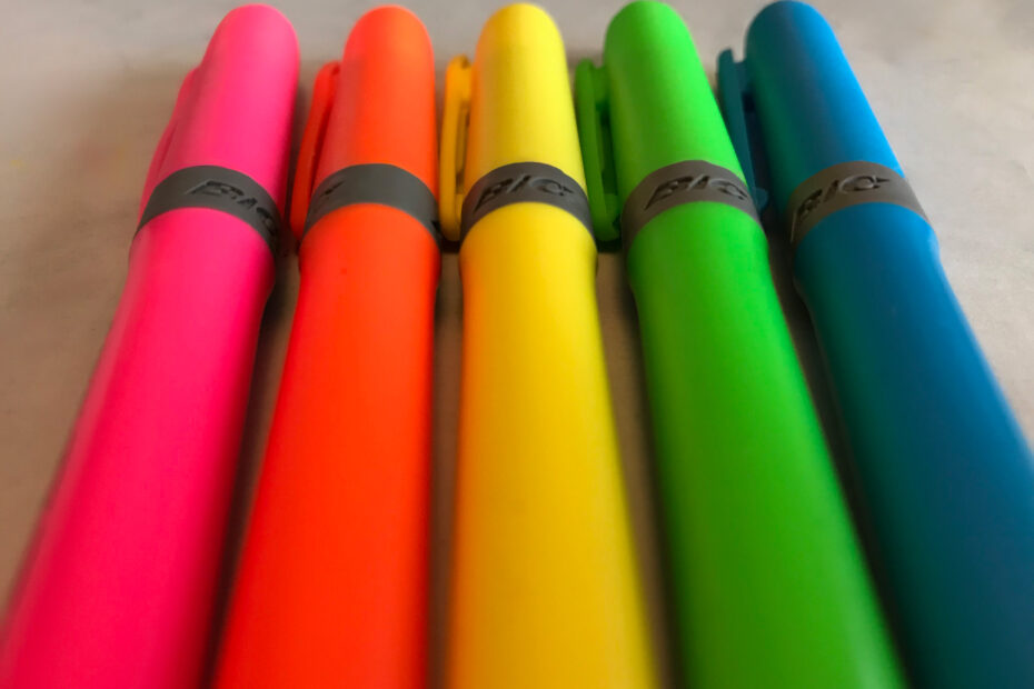 Close-up of five highlighters lined up on a table.